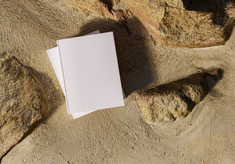 Blank book model placed on rocks in the sand, notebook mockup, mockup on nature background 03