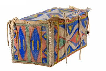 Indian painted rawhide box with leather cords isolated on white