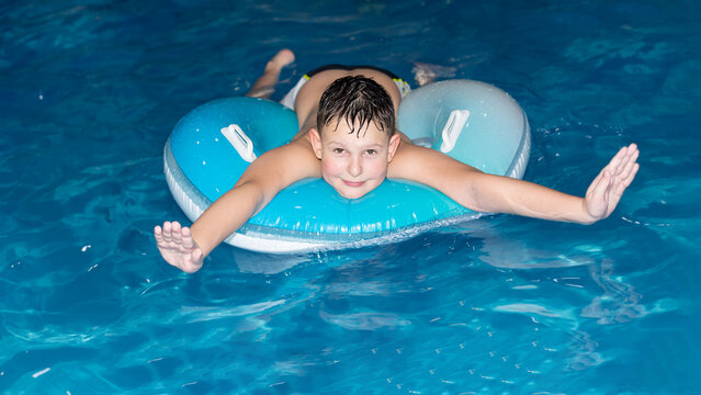 A smiling boy is bathing in the water. Sports and recreation. Healthy lifestyle - Powered by Adobe