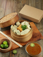 close-up of variation of somay in bamboo bowl