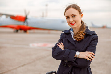Cheerful young woman standing outdoors at airport