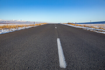 winter landscape and asphalt road