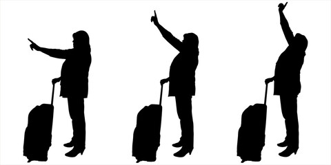 A businesswoman in a pantsuit waving with one hand while holding the handle of luggage on wheels with the other hand. The passenger points with his hand to an object above, below, in front of him. 