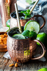 Close up of a Moscow Mule mocktail with bamboo straws, ready for drinking.