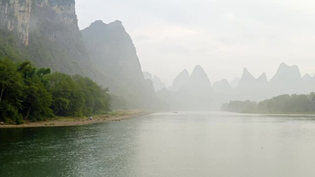 Aerial shot of the amazing Karst Mountains and the Li River in China on a hazy day.