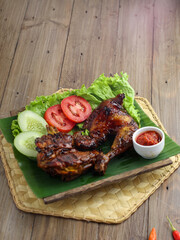 Delicious freshly baked crispy baked chicken is appetizing served on a wooden dish