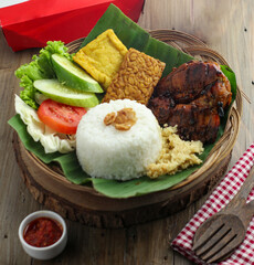 Delicious freshly baked crispy baked chicken is appetizing served on a wooden dish