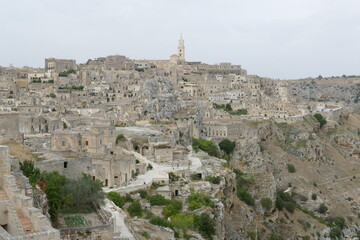 Fototapeta na wymiar panorama of Sasso Caveoso in Matera with typical rupestrian churches excavated inside the rock on the canyon carved by the Gravina River