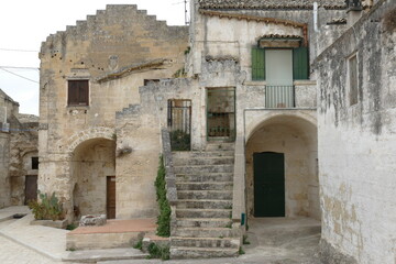 Fototapeta na wymiar typical street of Sasso Caveoso in Matera with the facade of rupestrian houses built by white sandstone