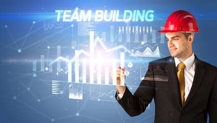 Young businessman with helmet drawing on virutal screen
