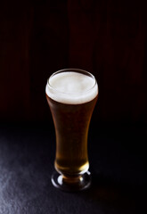 Glass of beer on dark background. Copy space. 