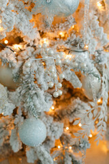 Christmas decorations on the New Year tree, toys and a garland are removed close-up. Christmas theme, screensaver or background