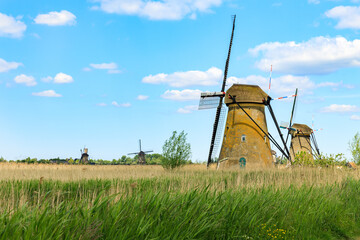 Landscape with old traditional historic dutch windmill house above the river in the Kinderdijk Park near Rotterdam, Netherlands