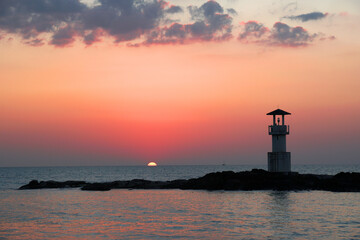 Landscape nature sunset and red  twilight sky with Silhouette  lighthouse on the rock at Nang Thong Beach at Khao Lak Phang Nga Thailand - Seascape chill vibe on the beach - beautiful sky  