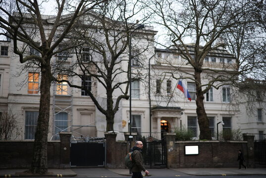 A person walks in front of the Russian embassy in London