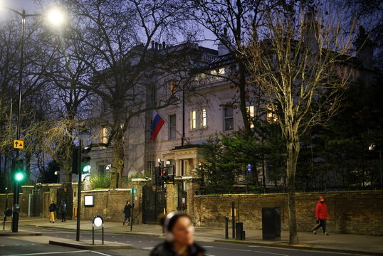 People walk in front of the Russian embassy in London