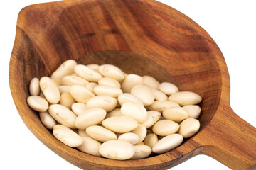 Lots of organic white beans with wooden cup, close-up, isolated on white.