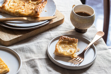 Breakfast  with apple pie  slice and coffe cup on kitchen table at the morning.