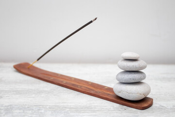 Aromatic incense sticks for aromatherapy and pebbles on white background