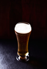 Glass of beer on dark background. Copy space.