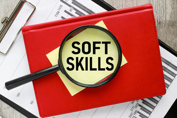 Soft Skills yellow sticky sticker under a magnifying glass. text on glass