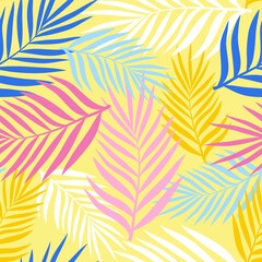 Fototapeta na wymiar Palm leaves of different colors on a pale yellow background. Seamless pattern for any use.
