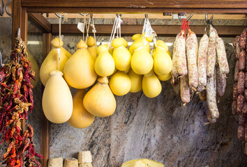 Typical Italian Shop window of cheeses and ham, delicacy. Concept of traditional food and cuisine....