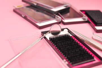 Equipment for eyelash extensions on pink background 