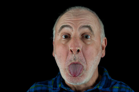 An Old Man Sticks His Tongue Out At The Photographer.