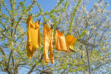 Children's underwear and boots hang on a string after washing and dry in the sun and wind in the...