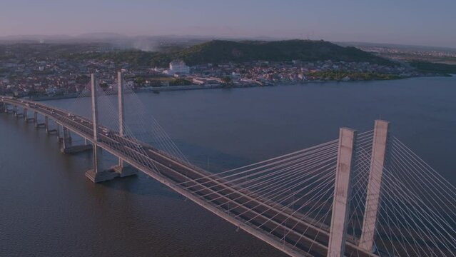 aerial view of the Jo&atilde;o Alves bridge on the Sergipe river in the city of aracaju with turning movement around as cars pass by the bridge