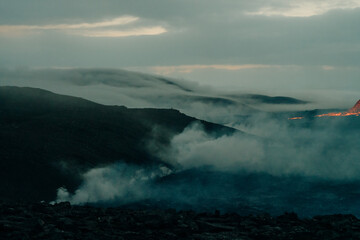 tourist looks at Fagradalsfjall, Iceland - June, 2021: volcano eruption near Reykjavik, Iceland