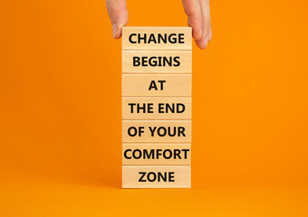 Out from comfort zone symbol. Wooden blocks with words Change begins at the end of your comfort...