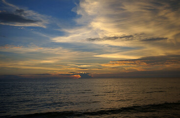 a cloud on the background of sunset over the sea in the summer evening in Spain