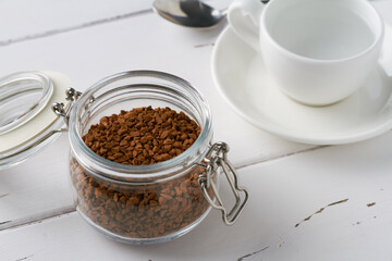 instant coffee in a glass jar white espresso cup white background