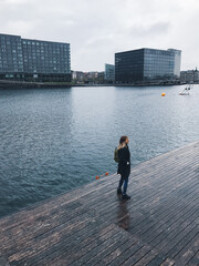 Young woman walking on the pier.