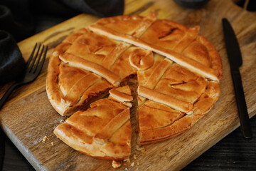 Empanada Gallega, traditional pie stuffed with tuna or meat typical of Galicia, Spain, on a wooden...