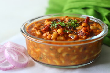 Black eyed beans or cowpea beans gravy. The gravy is cooked with onions, tomatoes and spices and by adding roasted coconut and onion garlic paste