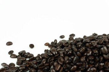 dark roasted arabica coffee beans on white background with copy space