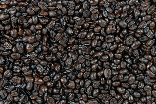 dark roasted arabica coffee beans  background and texture close up short on top view full frame