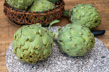 Fototapeta premium Fresh ripe green artichokes heads ready to cook