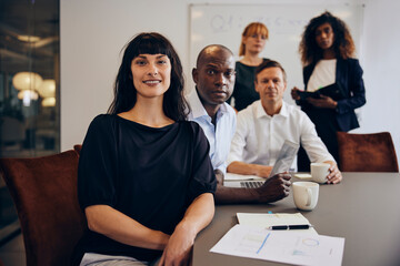 Confident businesspeople sitting in a boardroom