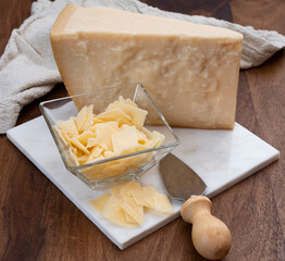 Flakes of parmesan cheese, italian hard parmigiano-reggiano cheese from Reggio Emilia region