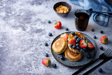 Banana pancakes with strawberries and blueberries