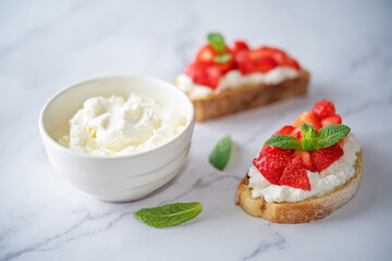 Strawberry ricotta sandwiches with mint leaves