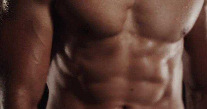 Moving around while flexing and being topless, tilt shift