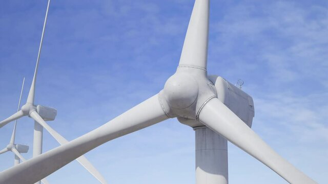 Slow rotation of wind turbine blades. Blue sky on background. Green energy production, wind farm. Alternative, renewable sources generating. Aerial view. Ecology. Realistic 3D Render concept 4K clip