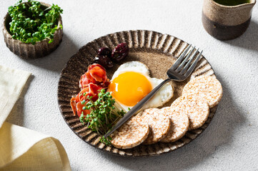 Romantic Breakfast on Women's Day - fried eggs in the shape of a heart and olives. Healthy breakfast. Rice cakes with eggs and hamon. Romantic breakfast. Top view.