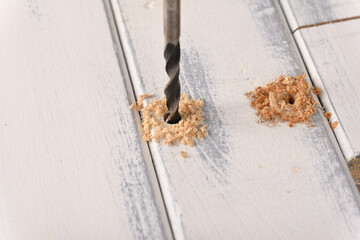 Drill wood board using drill.