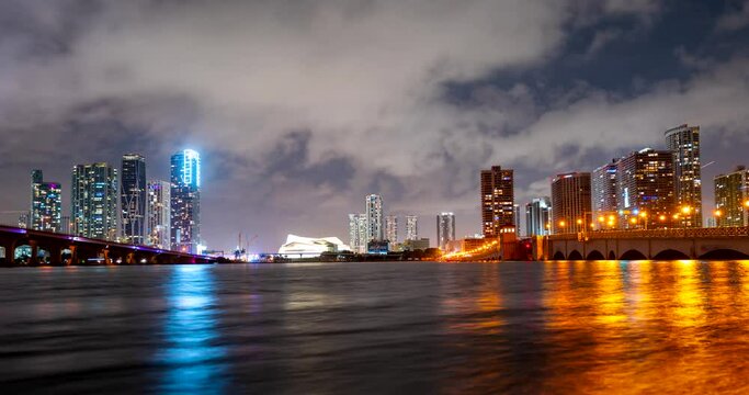 Miami panorama time lapse. Night sky timelapse on Miami beach city. Fast timelapse, motion video of clouds landscape city, dramatic light. MacArthur downtown, Causeway city.